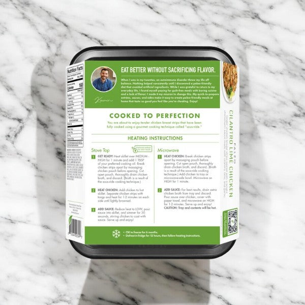 The 16 oz. package of Kevin's Cilantro Lime Chicken sits on the marble surface, boasting the slogan "Eat Better Without Sacrificing Flavor." Clearly labeled with cooking instructions and nutritional info, this frozen meal offers a zesty cilantro lime twist.