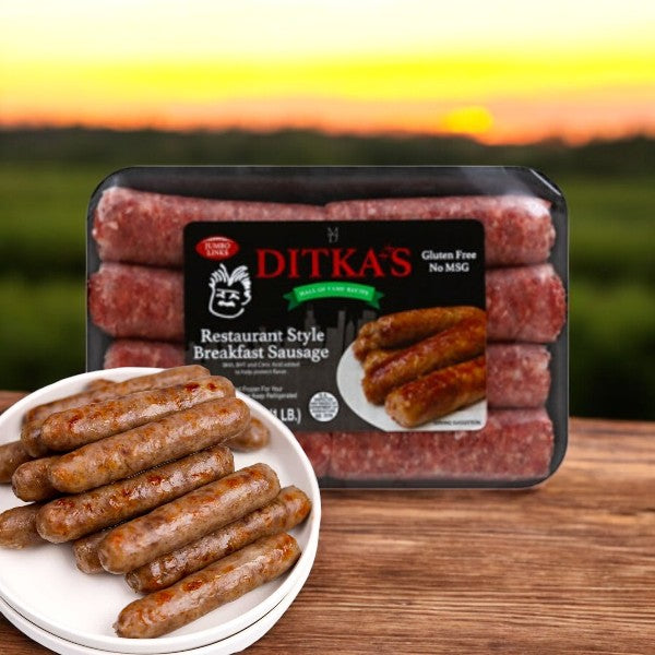 A pack of Vienna Beef's Ditkas Breakfast Sausage, Restaurant Style (16 oz.), sits on the table with a plate of sizzling sausages in front, set against a blurred sunset for a premium pork experience.