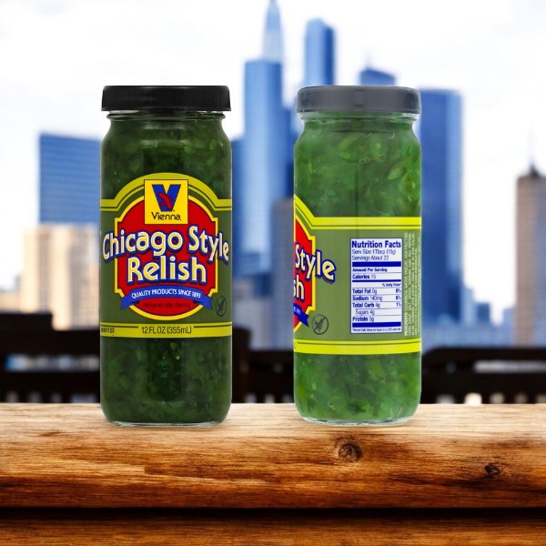 Two jars of Vienna Chicago Style Relish stand on a table against a cityscape. One reveals its front label, the other its nutrition facts, ideal for your next Vienna Hot Dog Kit with 32 Chicago Style Hot Dogs, Condiments, and Buns by Vienna Beef.