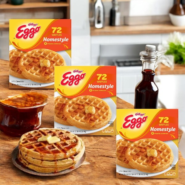 Kellogg's Eggo Homestyle Waffles, 72-count-3 pack, are displayed on a kitchen counter with a waffle plate, syrup bottle, and spread jar.