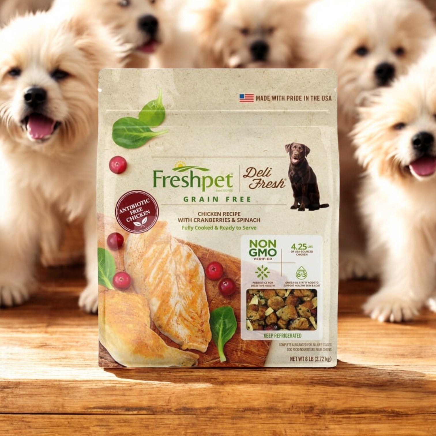 A pack of Freshpet Deli Fresh dog food, featuring Chicken with Cranberries & Spinach, is on a wooden table, surrounded by playful puppies.