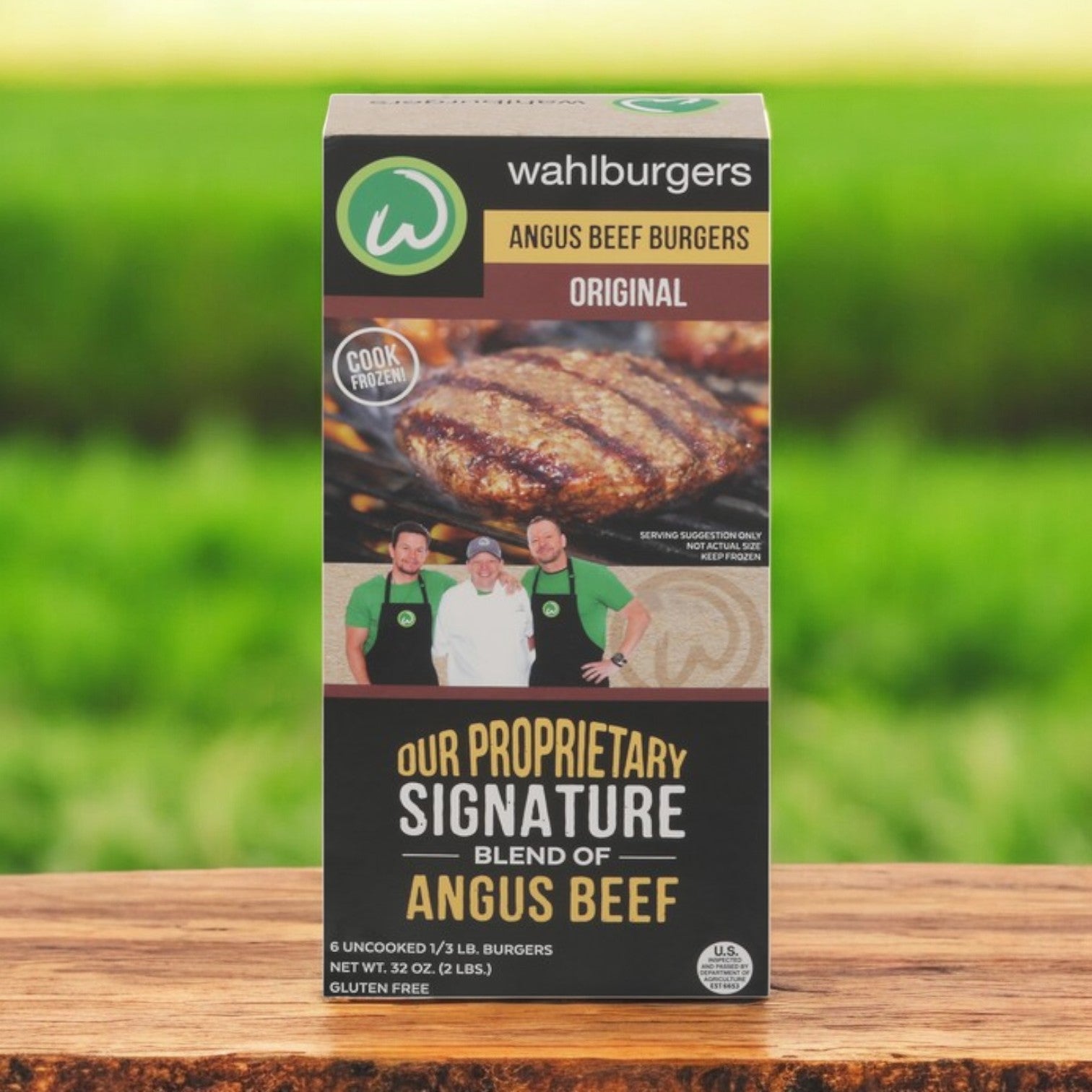 Wahlburgers Angus Beef Burgers, Original flavor, come in a 6 ct, 32 oz pack (3 boxes total) with gluten-free restaurant-quality taste. The packaging highlights a mouthwatering cooked burger image and features three people on the front. Perfect premium quality burgers for any occasion!.