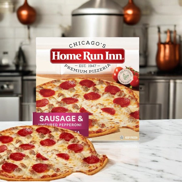 A Home Run Inn Family Sausage and Uncured Pepperoni Pizza box, 21.5 oz, is in the kitchen displaying its mouthwatering flavor and tempting your taste buds.