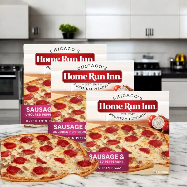 Three boxes of Home Run Inn Family Sausage and Uncured Pepperoni Pizza, 21.5 oz, are displayed on a kitchen counter, highlighting this tasty Home Run Inn 3-count pizza pack that's perfect for gatherings.