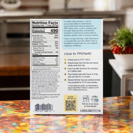 The back of Luke's Organic Baked Lobster Mac & Cheese box elegantly displays nutrition facts, preparation instructions, and a heartwarming brand story. A hint of gourmet comfort food awaits each bite. Discover more via the QR code and website URL at the bottom.