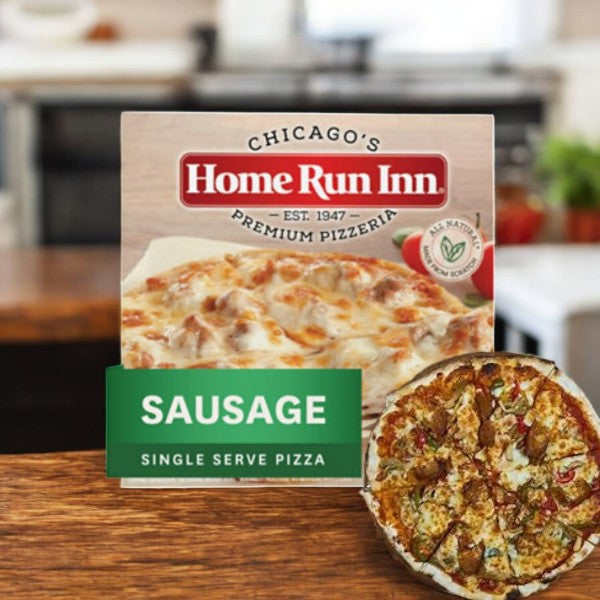 A Home Run Inn Mini Personal Pizza box, labeled "Classic Frozen Sausage Pizza, 8.5 oz. - 1 Count," sits on the counter with a perfectly cooked sausage pizza beside it.
