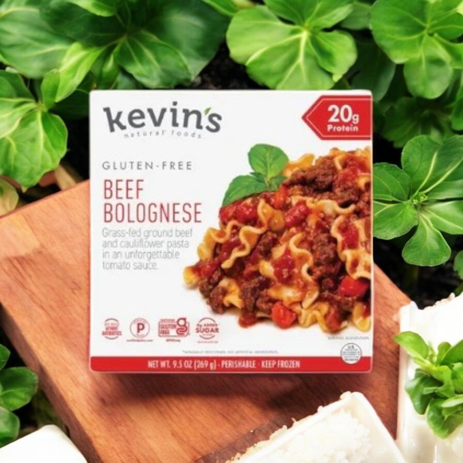 Box of Kevin's 4 Pack Combo - Gluten-Free Gourmet Meals with chef-crafted grass-fed beef and cauliflower pasta, highlighting its 20g protein content. Surrounded by greenery.