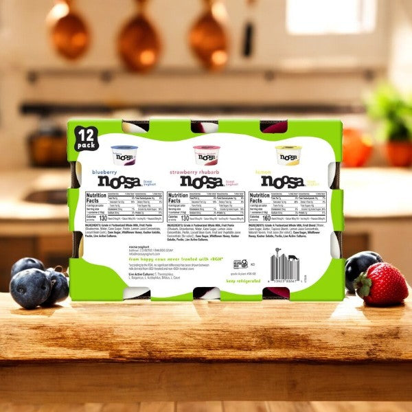 A 4-pack of Noosa Yoghurt Variety Pack, 12 oz each, sits on a kitchen counter with fresh blueberries and strawberries nearby—a probiotic-packed treat for your taste buds.