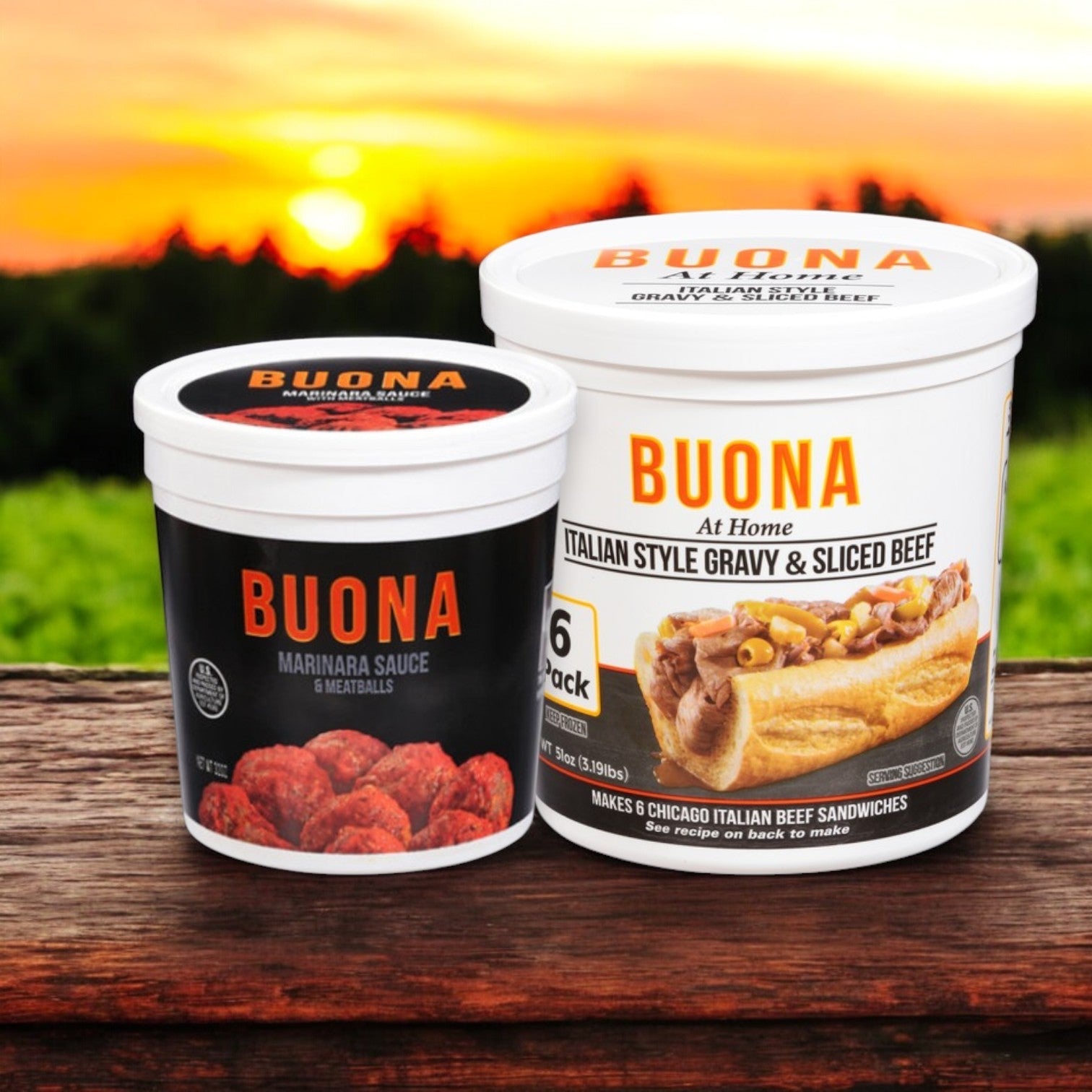 Two containers of Buona brand products rest on a wooden surface, highlighting the Italian Meal Bundle: Buona Marinara Sauce & Meatballs—32 oz and Gravy & Sliced Beef, Italian Style—6 pack. The scene is set against an inviting outdoor backdrop.