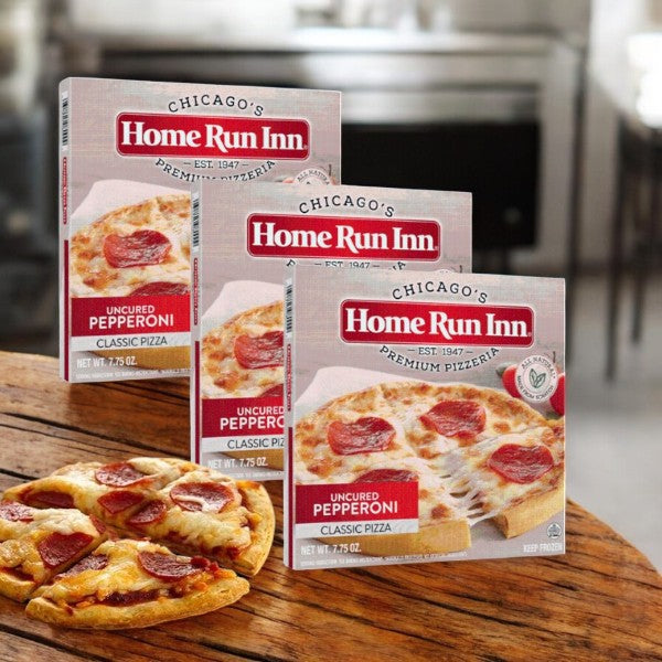Home Run Inn Classic Crust Uncured Pepperoni Frozen Pizza, 7.75 oz., in a 3-count package is displayed on a kitchen counter, with one partially sliced pizza in front.