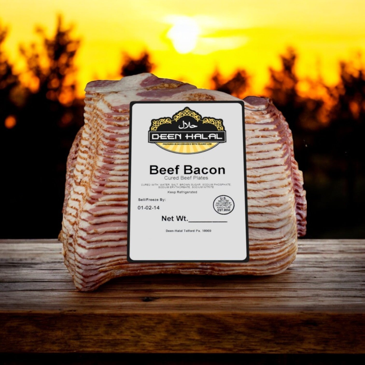 A Deen Halal Turkey Pastrami Slab, approximately 4.0 lb, is displayed on a wooden surface against a warm sunset background.