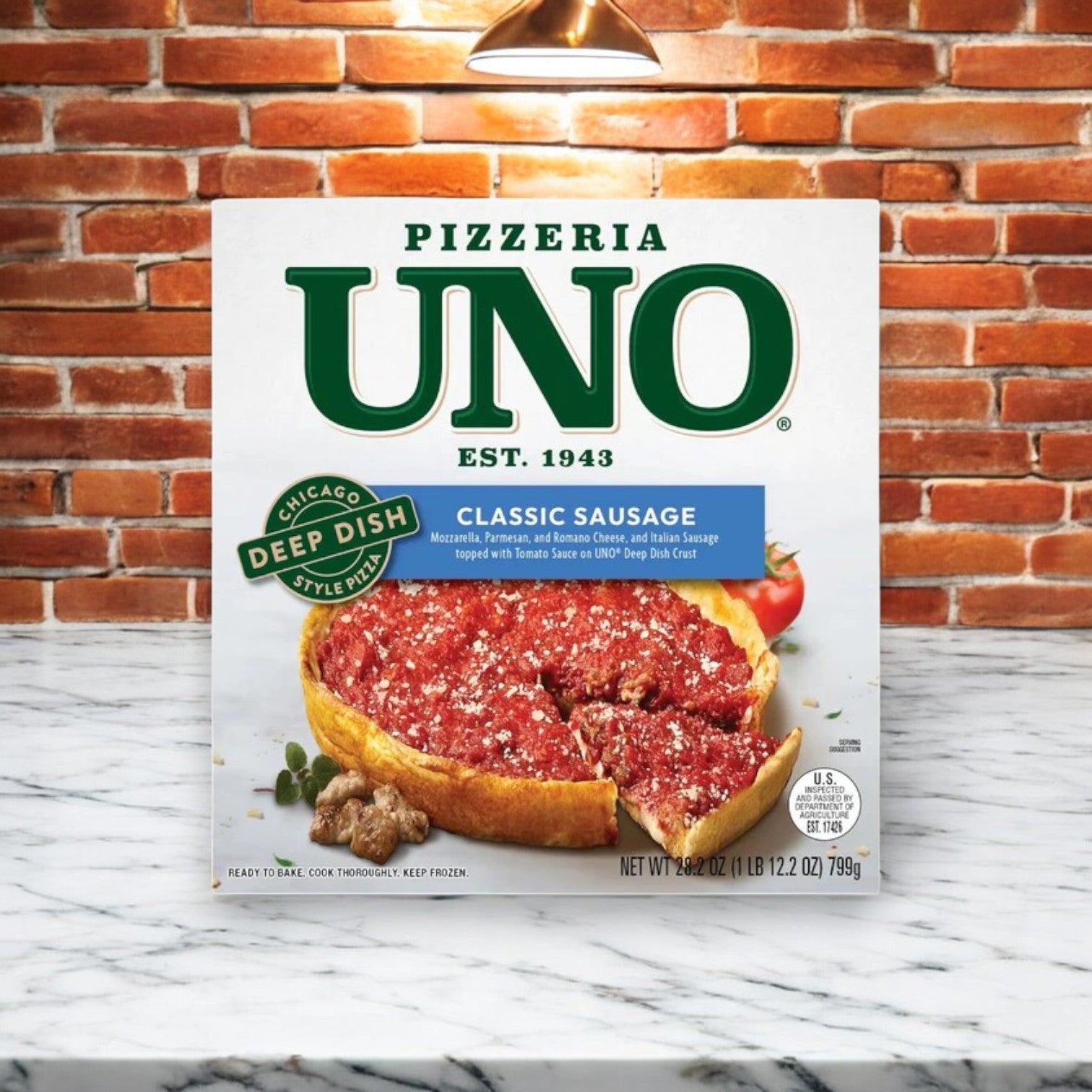 A box of Easy Lunches' Chicago's Deep Dish Mix! featuring 4 total deep dish pizzas, set against a brick and marble background, captures the essence of Chicago's deep-dish pizza.