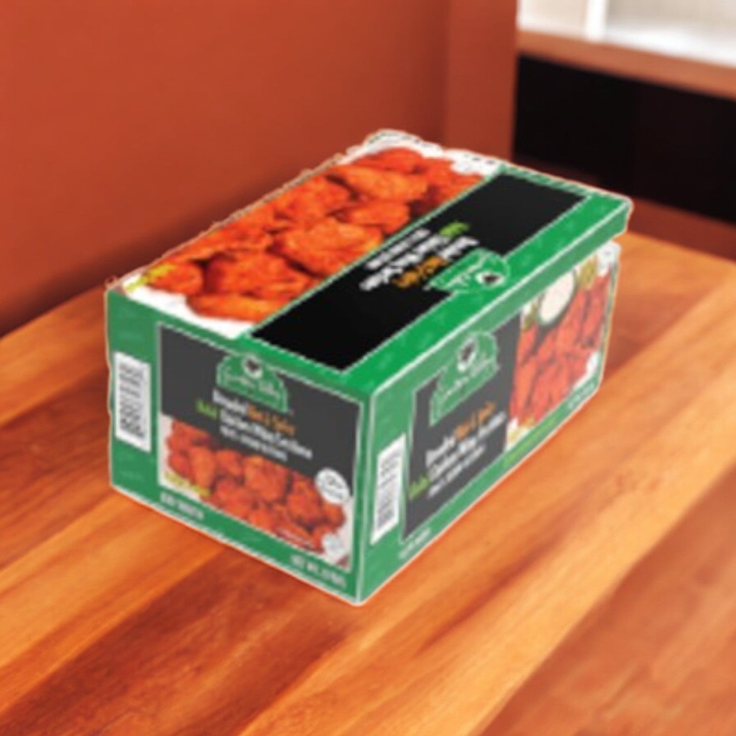 A box of Garden Valley Breaded Hot & Spicy Halal Chicken Wings, fully cooked and weighing 10 lbs, sits on a wooden counter.