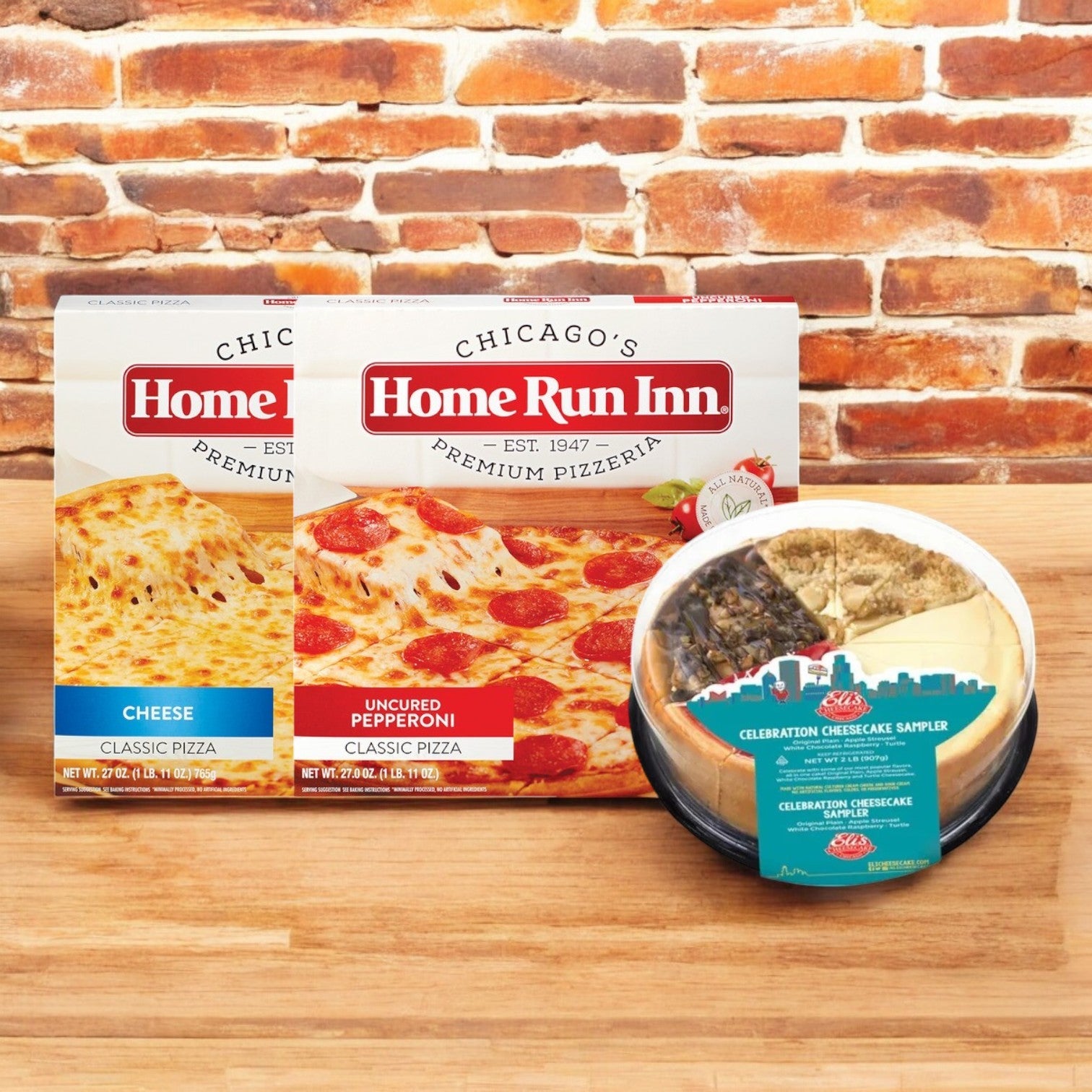 Easy Lunches showcases their Eli's Cheesecake Celebration Sampler & Home Run Inn Pizza Combo in front of a brick wall.