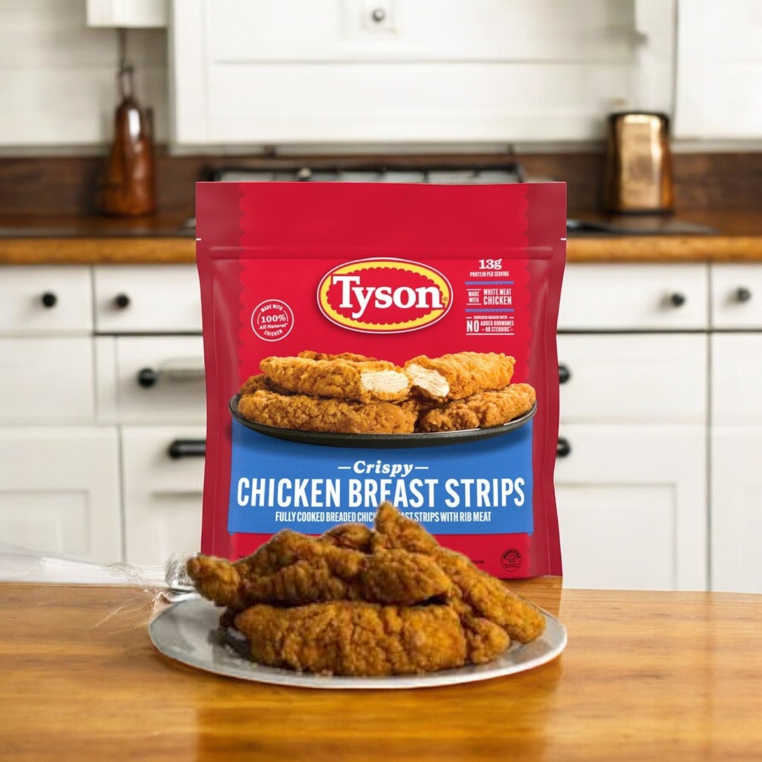 A bag of Tyson Fully Cooked Crispy Chicken Strips, 3.5 lbs., lies open on the kitchen counter, with some strips appetizingly arranged on a plate for a quick meal.