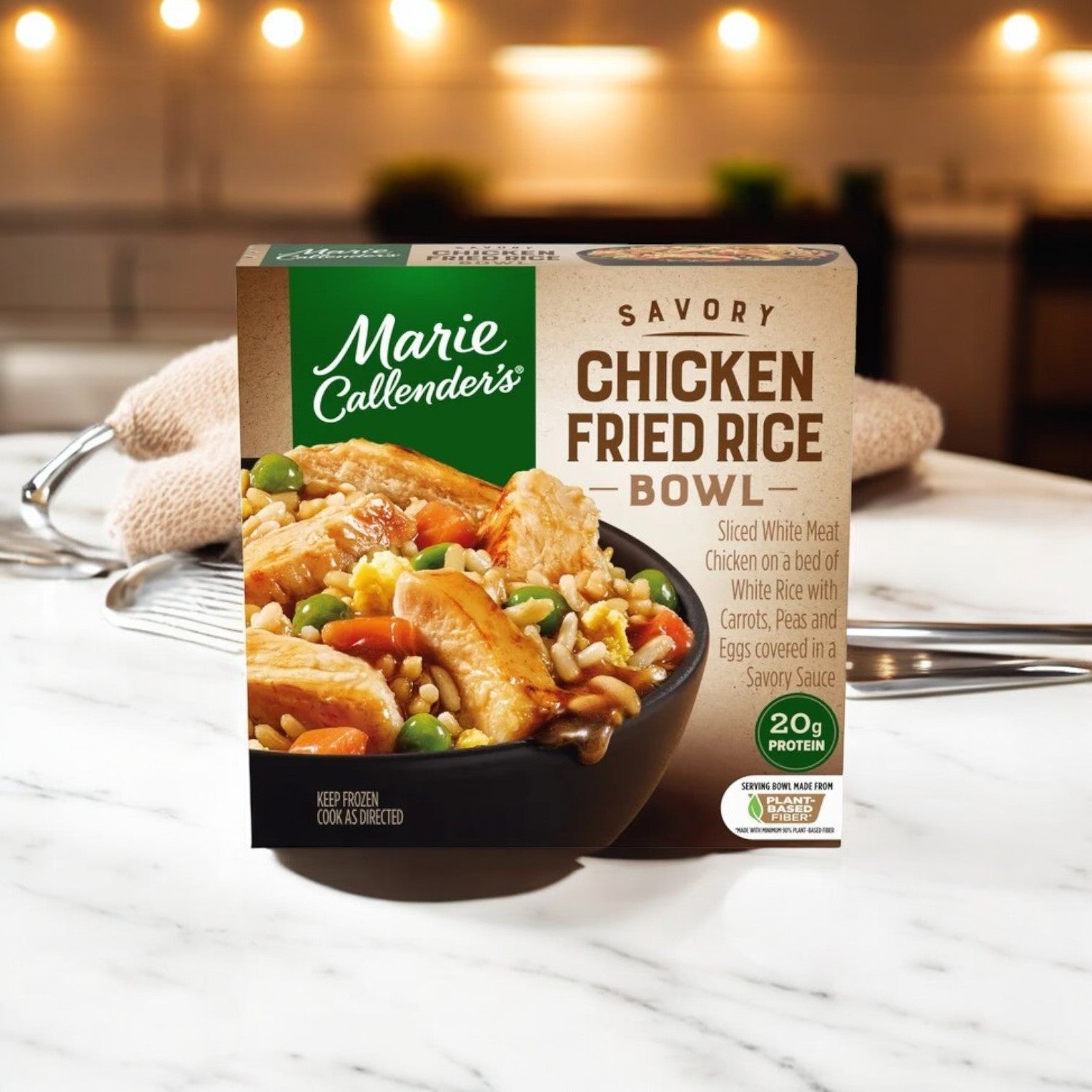 The package of Smart Ones' Marie Callender's Savory Chicken Fried Rice Bowl 11 oz rests on the counter, promising a tasty meal with "20g of protein" and a "Keep Frozen" note. This frozen dinner pairs well with Marie Callender's Fettuccini with Chicken & Broccoli for a satisfying meal.