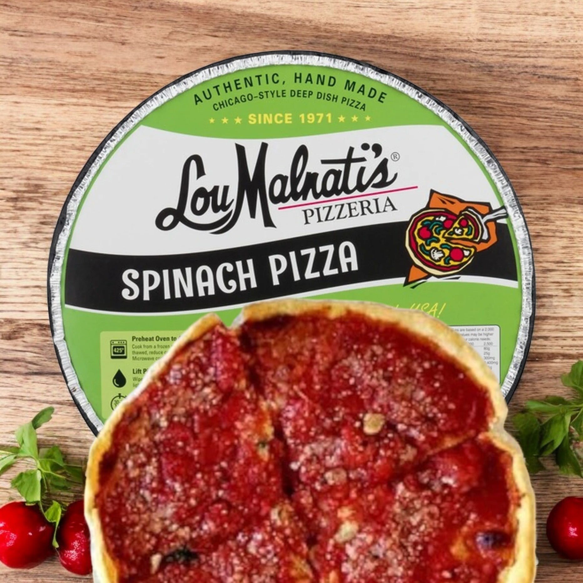 A 23 oz. frozen Lou Malnati's Pizza Spinach package sits on a wooden surface, surrounded by fresh tomatoes.