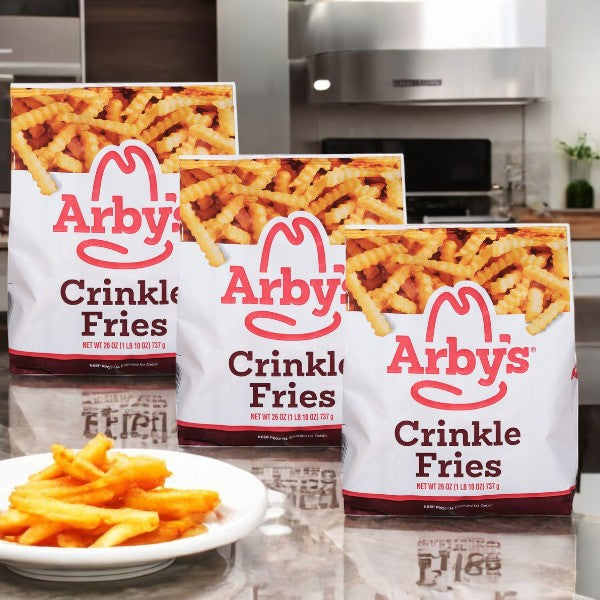 Three packs of Arby's Crinkle Fries-26 Oz-3 Count rest invitingly on the kitchen counter, with a bowl of crispy fries showcasing their savory flavor in the foreground.