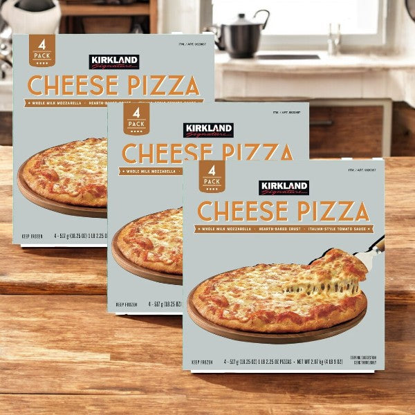 Three packs of Kirkland Signature Cheese Pizza, with four in each pack, featuring premium mozzarella and hand-stretched crusts, are displayed on a wooden countertop in a kitchen setting.