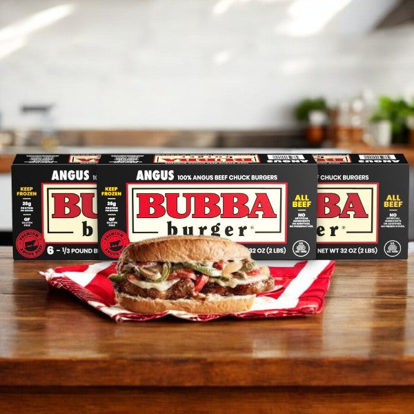 Boxes of Bubba Burger Burgers, Angus Beef-3 Count, and a cooked Angus beef burger on a red-striped napkin in a kitchen setting, highlighting premium flavor.