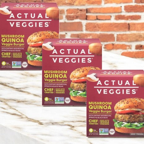 Actual Veggies Mushroom Quinoa Veggie Burger- 3 Count rests on a marble surface, set against a rustic brick wall backdrop.