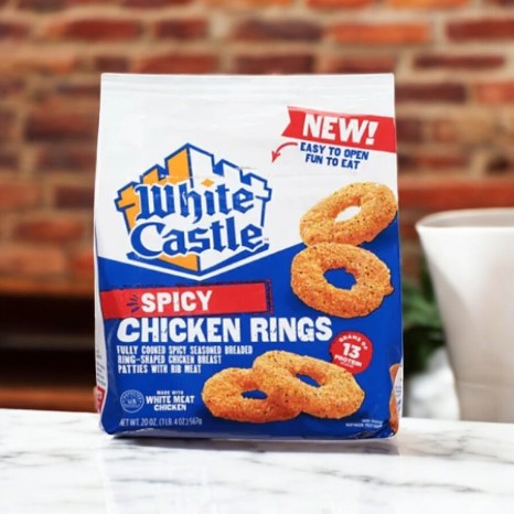 A White Castle Spicy Chicken Rings-20 Oz package sits on a marble surface with a "New!" label, promising a flavorful snack of crunchy breaded chicken that teases the taste buds.