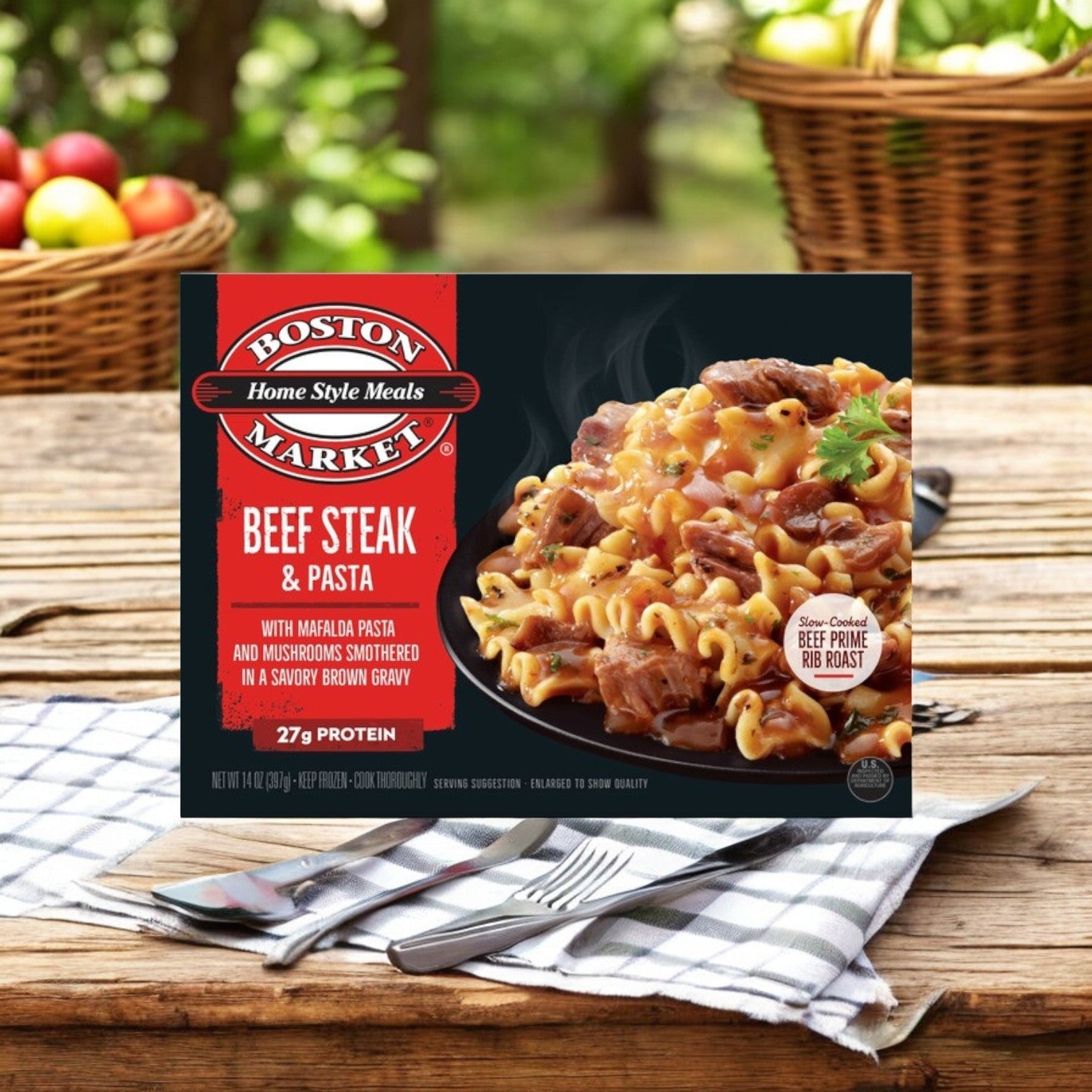 A 14 oz. Boston Market Home Style Meals Beef Steak & Pasta, from Smart Ones, rests on an outdoor table with baskets in the background.