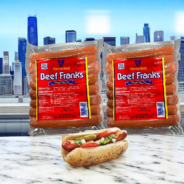 Two 32 oz packages of Vienna Beef Frank Hot Dogs and a mustard-topped hot dog sit on a marble surface against a city skyline, capturing the essence of Chicago-style hot dogs.