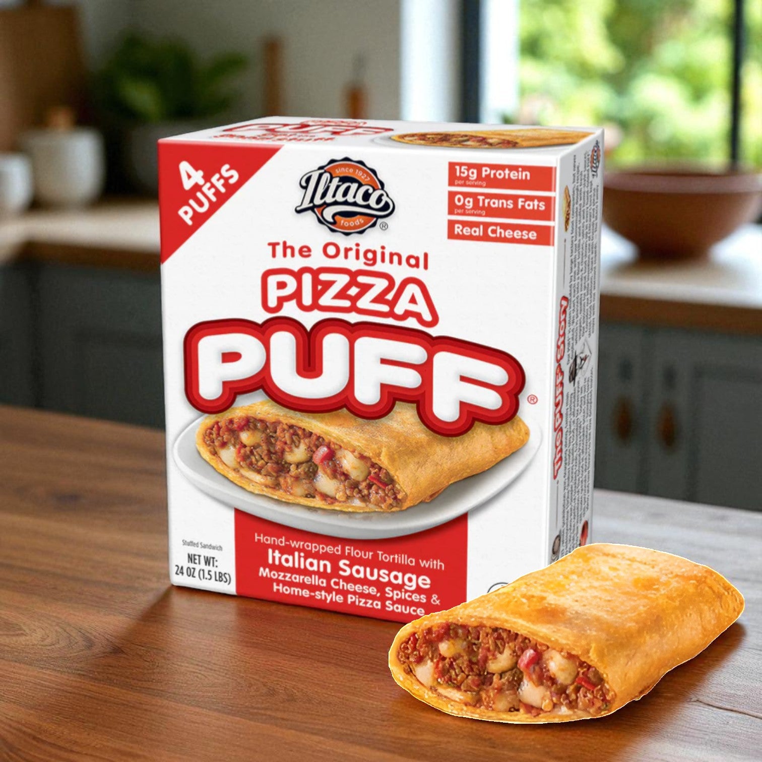 A box of Itaco Foods Original Pizza Puff - Sausage (4 pizza puffs, 24 oz - 3 packs) sits on a kitchen counter, with one crispy pastry pizza puff displayed in front of the box.