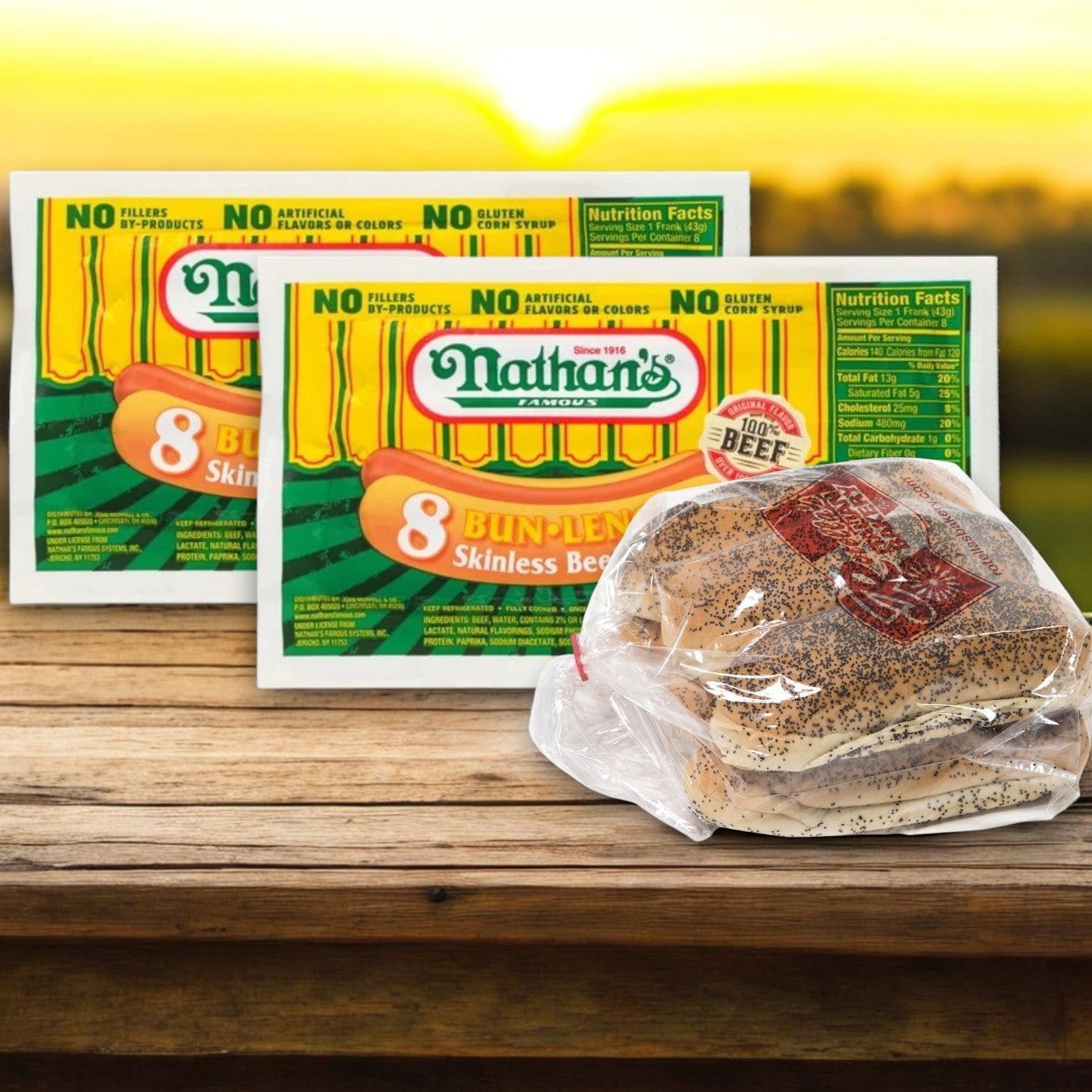 The Nathan's Bundle, featuring 16 Nathan's Famous Hot Dogs and 16 buns, rests on a wooden table against a sunset backdrop.
