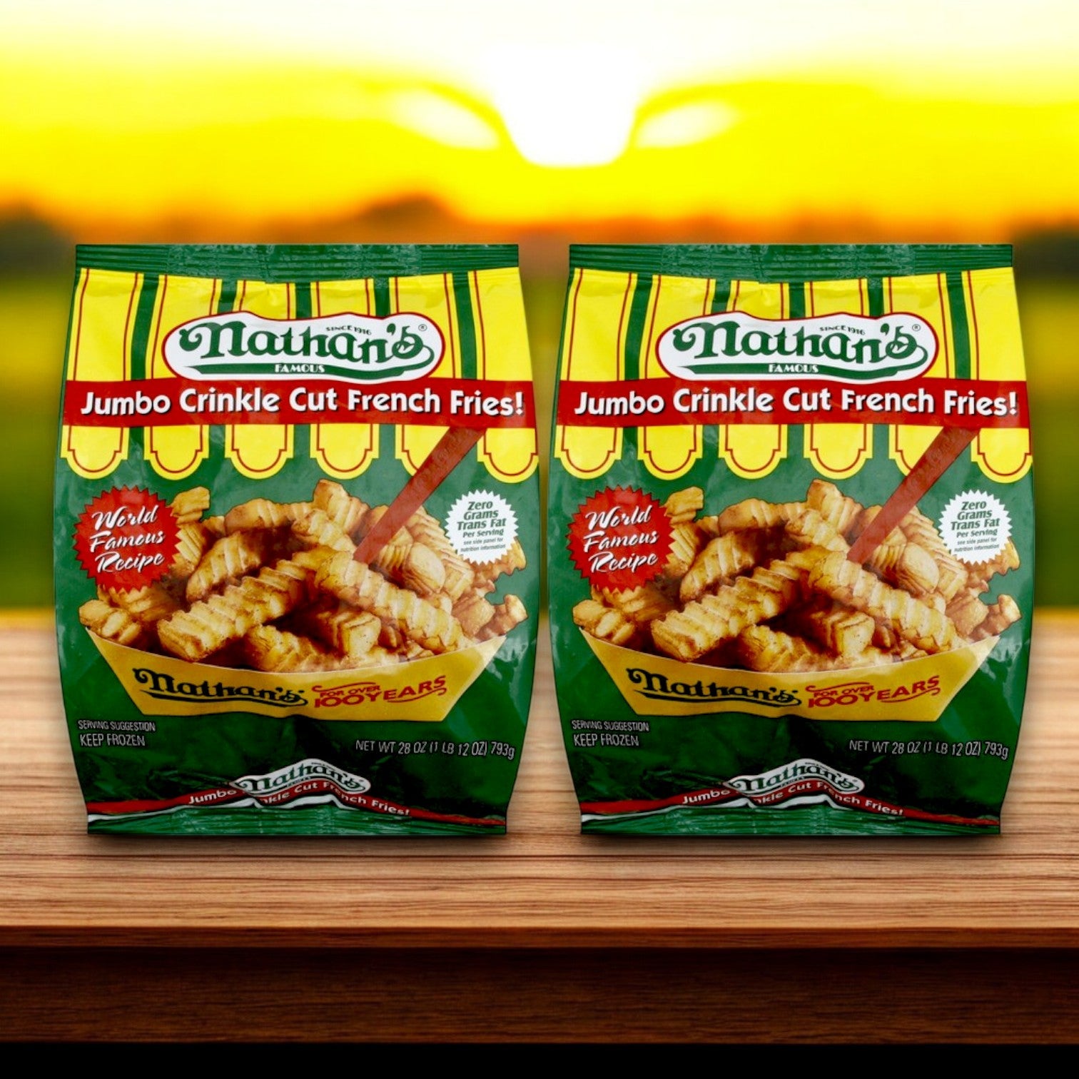 Two bags of fries from the Nathan's Hot Dog Bundle – including 16 hot dogs and buns – rest on a wooden surface, perfectly capturing a sunset essence. Ideal for pairing with Nathan's Famous Franks in soft buns.