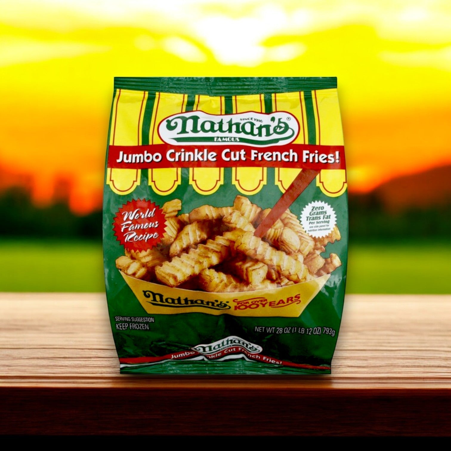 Enjoy Nathan's Famous Crinkle Cut Jumbo French Fries with a sunset backdrop. Prominent text highlights "World Famous Recipe" and "No Trans Fat." Savor the flavor of these 28 oz fries.