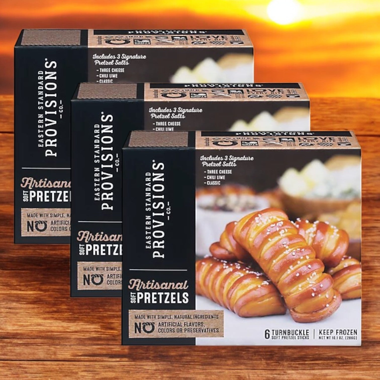 Explore the Turnbuckle Pack from Eastern Standard Provisions, featuring 18 artisanal soft pretzels and three varieties of pretzel salt. Each box emphasizes natural ingredients.