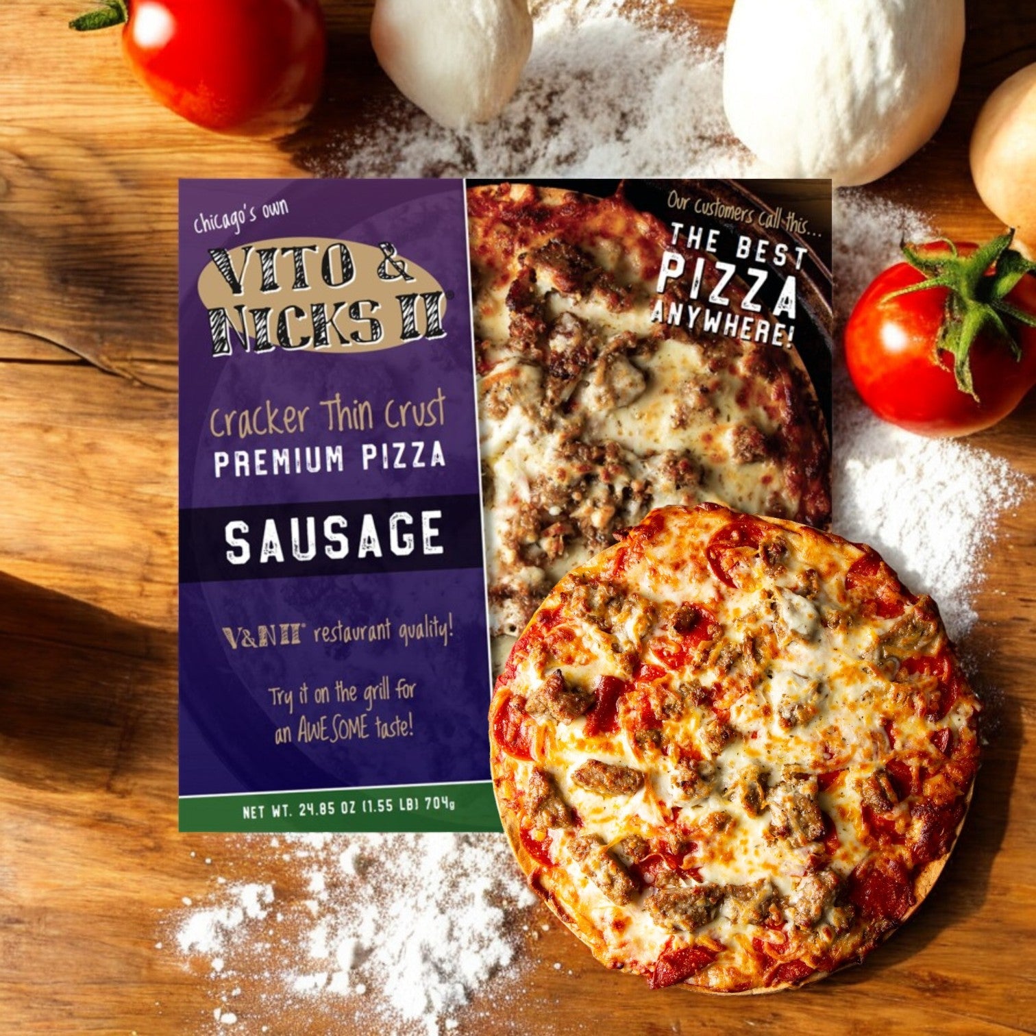 An open package of Vito & Nick's II Cracker Thin Crust Sausage Pizza, 24.85 oz, rests on a flour-dusted wooden surface, surrounded by fresh tomatoes.