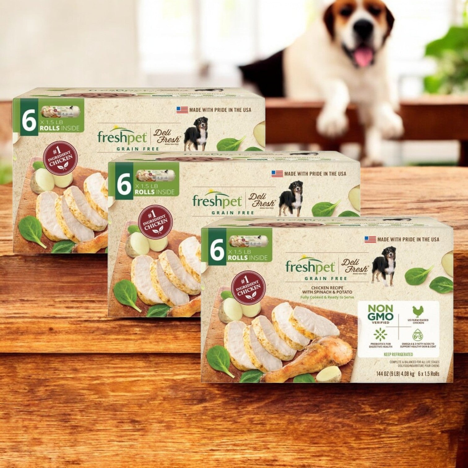 Displayed on a wooden surface are three boxes of Freshpet Deli Fresh Grain-Free Chicken Recipe Rolls, known for their high-quality protein and nutrient-rich ingredients, with a blurred dog in the background.