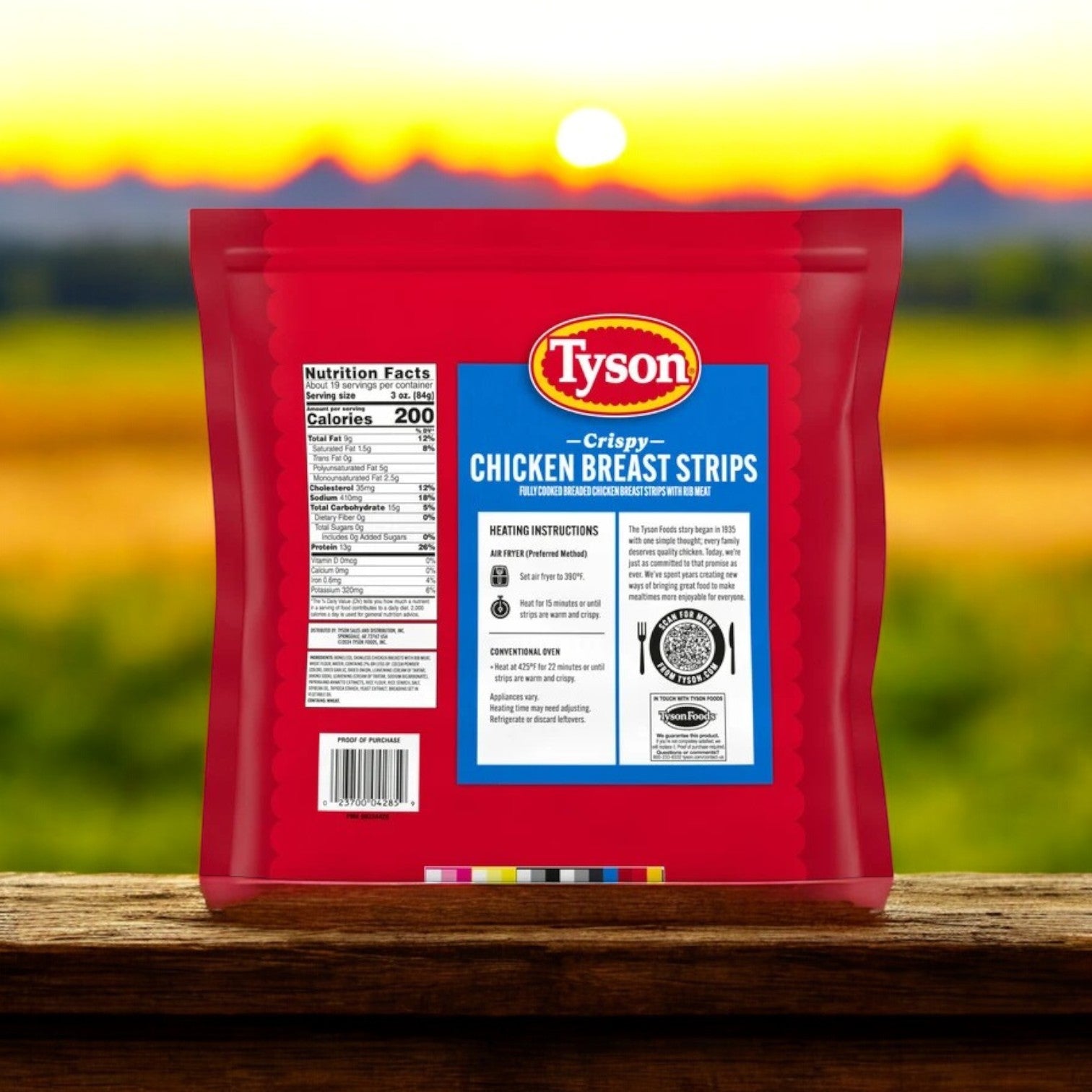 A 3.5 lb bag of Tyson Fully Cooked Crispy Chicken Strips sits on a wooden surface, ready for a quick meal with a blurred sunset backdrop. Perfect for any occasion.