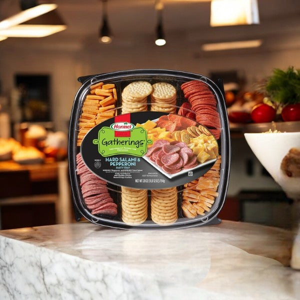 A Hormel Party Tray, Hard Salami & Pepperoni-1 Count from Hormel displays an elegant assortment of meats, cheese, and crackers on a marble kitchen countertop.