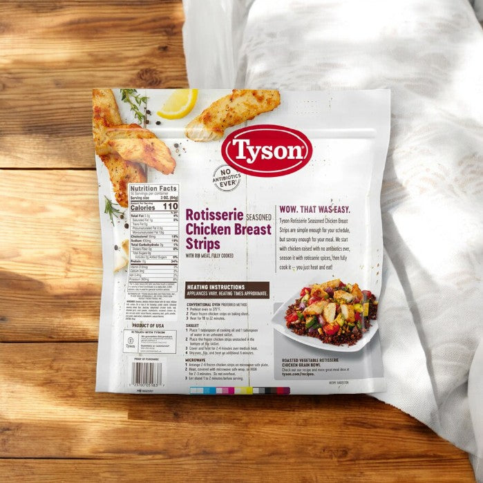 A package of Tyson Rotisserie Seasoned Unbreaded Chicken Breast Strips - 3 Bags (48 oz Each) is on a wooden surface, featuring high protein content and nutrition facts. The pack suggests a delightful dish idea, emphasizing the versatility of these chicken strips.