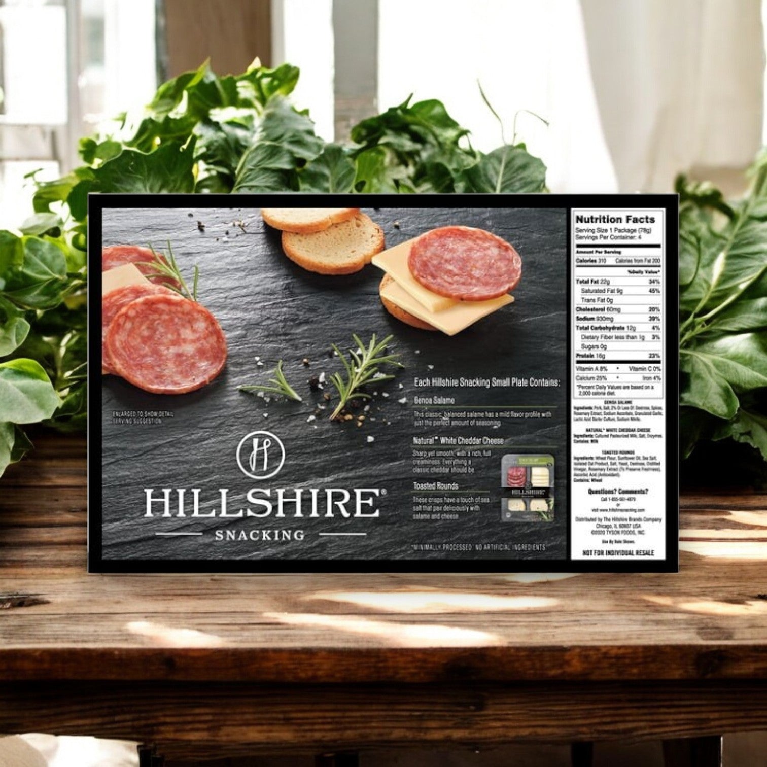 Hill Shire's Hillshire Snacking Plates offer a convenient snack featuring white cheddar and Genoa salame on crackers, elegantly garnished with rosemary. Nutritional facts are conveniently displayed on the side of this 12-count package.