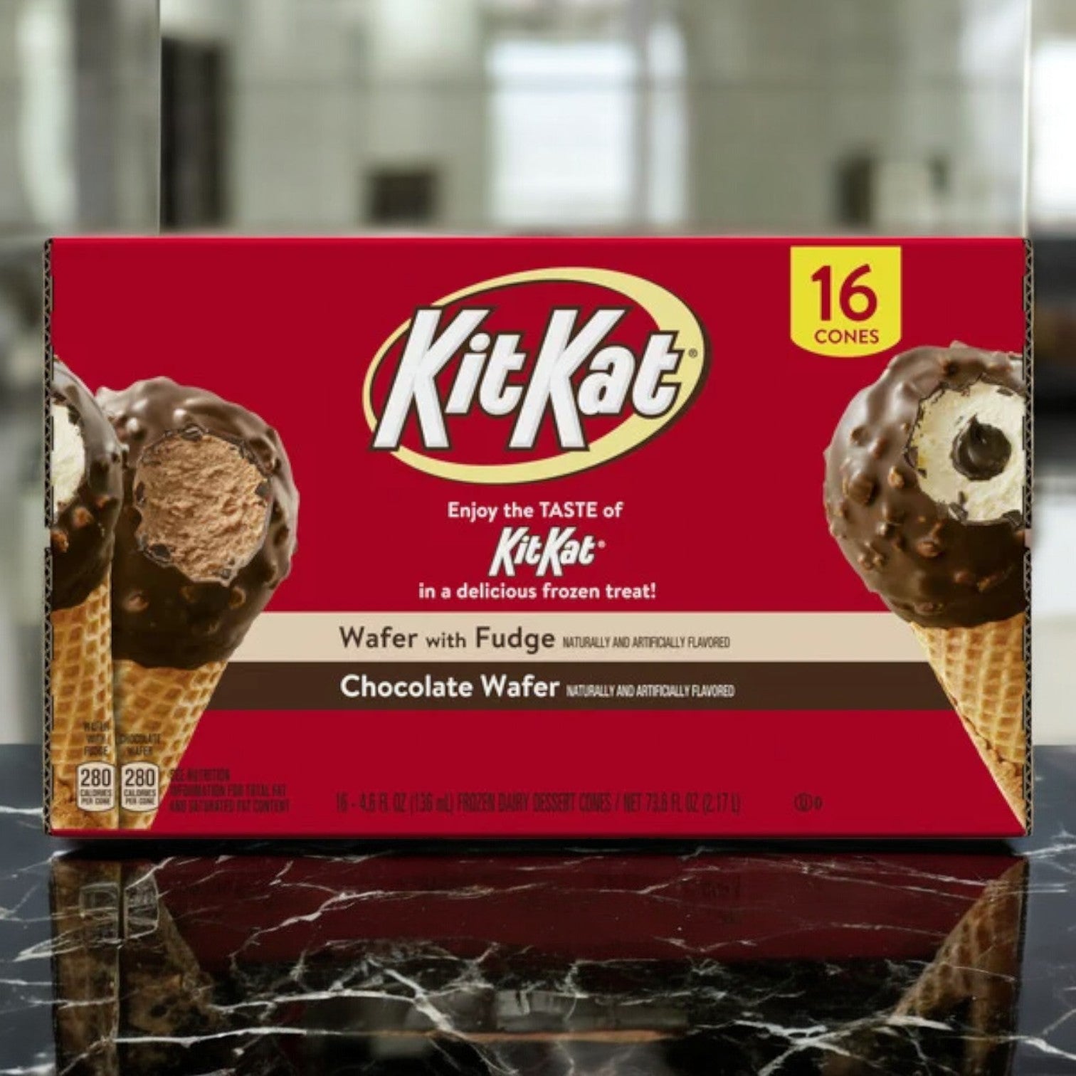 The Nestle Kit Kat Drumstick Ice Cream Cones Variety Pack offers a delicious mix of fudge and chocolate wafer flavors. This 16-count box includes images of two cones on a marble surface, making it an irresistible treat for any occasion.