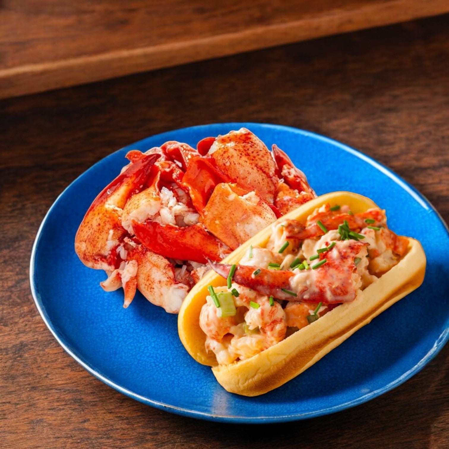 A seafood gourmet delight: Easy Lunches' Maine Lobster Meat Claw and Knuckle served on a blue plate with chives, set on a wooden table.