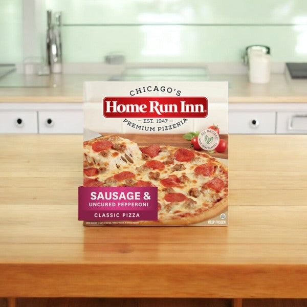 A box from the Home Run Inn Variety Pack, featuring 4 pizzas with rich mozzarella cheese toppings, sits invitingly on a wooden kitchen counter.