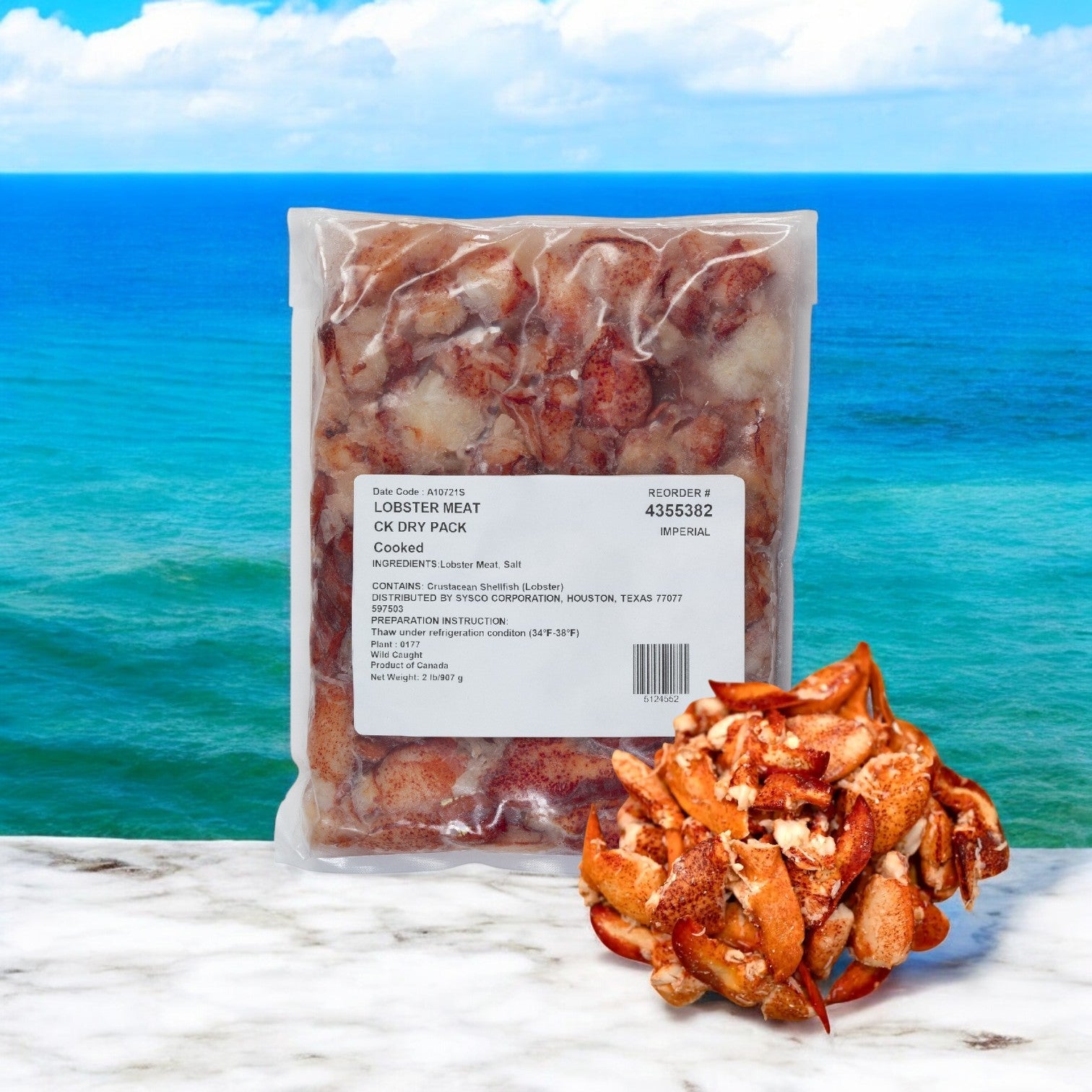 A vacuum-sealed package of Easy Lunches Maine Lobster Meat Claw and Knuckle - 2 Pounds rests on marble, with loose claw and knuckle pieces nearby. The ocean view completes the scene.
