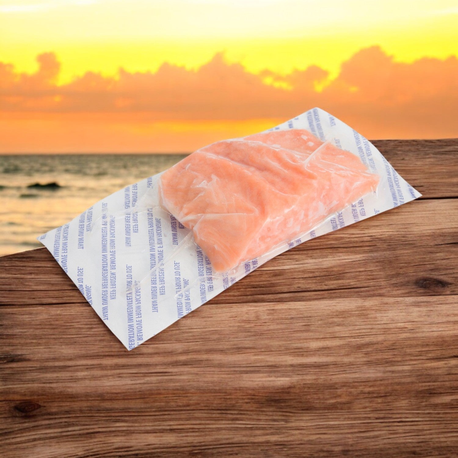 The Salmon Atlantic Portioned Skinless 6oz by Portico Classic Seafood is vacuum-sealed on a wooden surface, with an ocean and orange sunset backdrop, promising rich Omega-3 benefits within its 10 lbs. box.