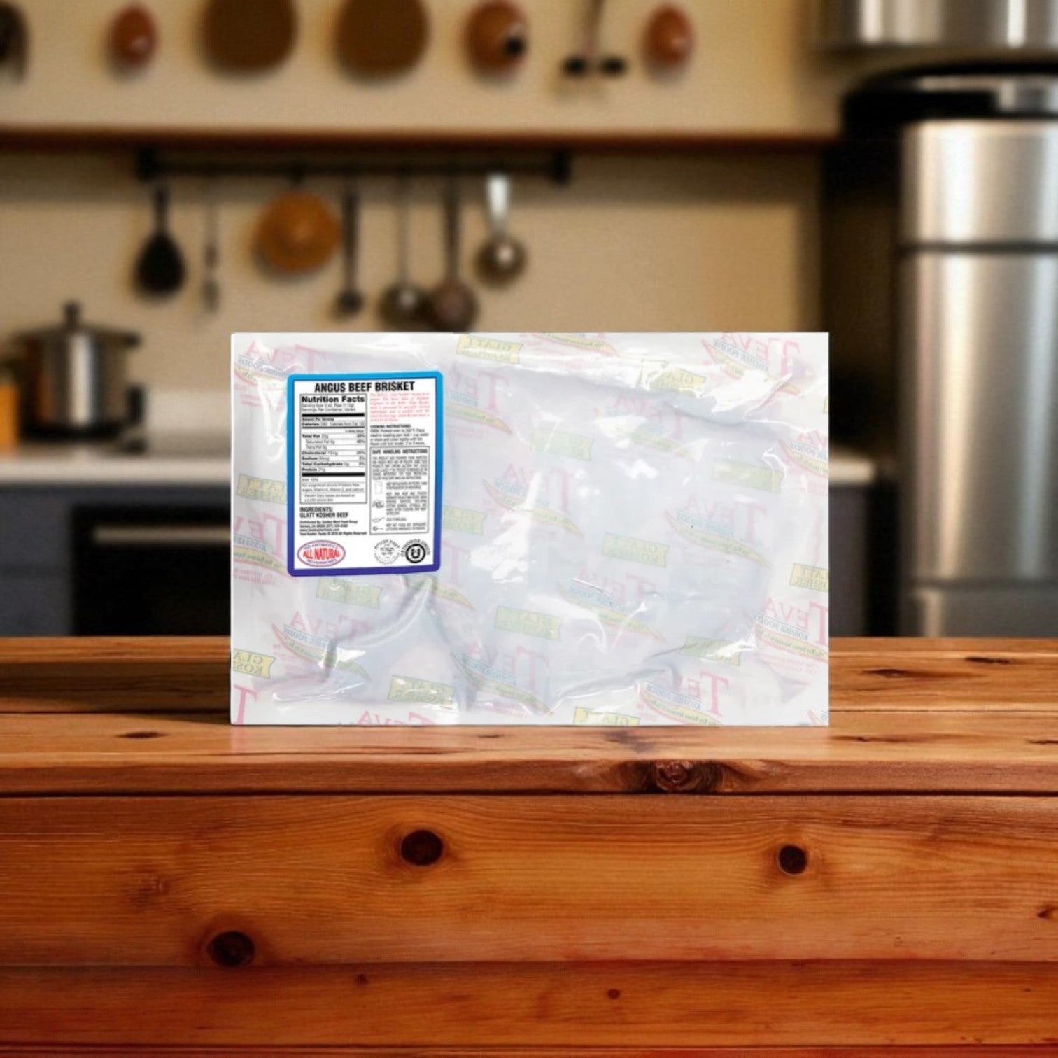 A vacuum-sealed package of Teva Kosher Foods Teva Glatt Kosher Angus Beef Brisket (2.78 lb, 1 case) rests on a wooden countertop, set against a kitchen backdrop with hanging utensils and pots.