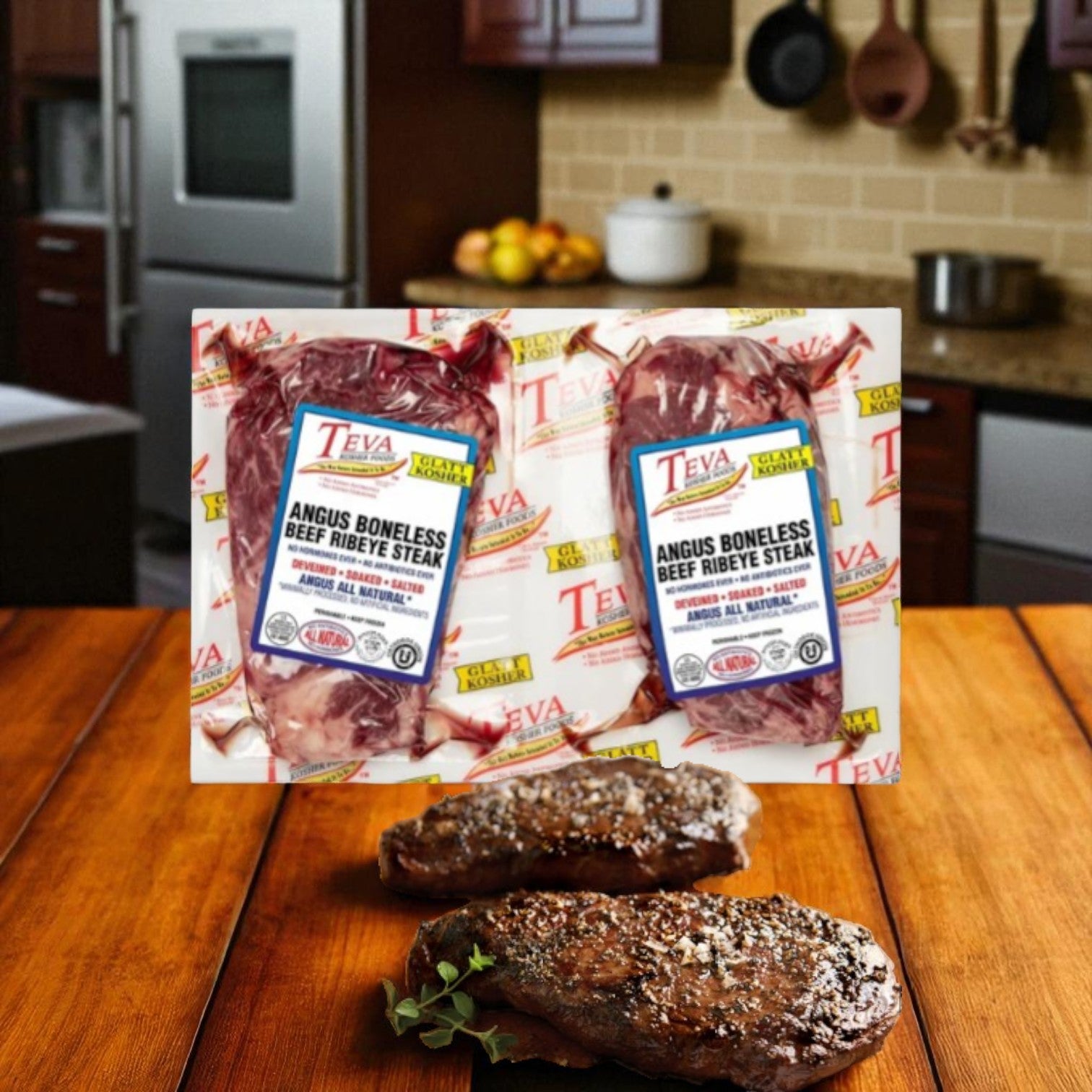 Teva Kosher Foods Teva Glatt Kosher Angus Boneless Ribeye Steak, 2-count-1 Pack is shown on a kitchen counter, with two cooked steaks in frontâperfect for enjoying all-natural Angus beef flavor at home.