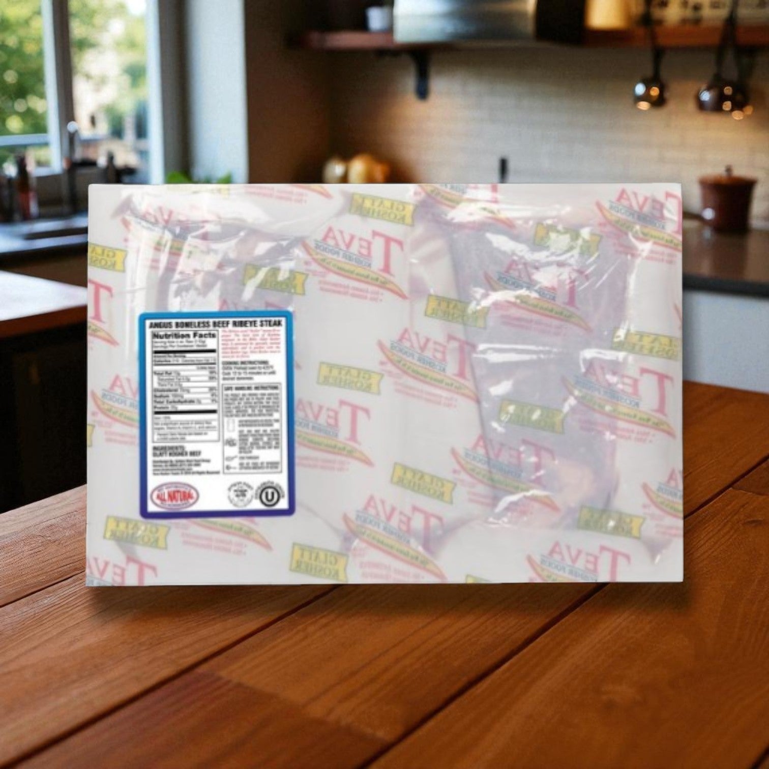 A pack of Teva Glatt Kosher Angus Boneless Ribeye Steak (2-count) from Teva Kosher Foods sits on a wooden kitchen counter, ready to bring premium, all-natural Angus beef flavor to your next meal.