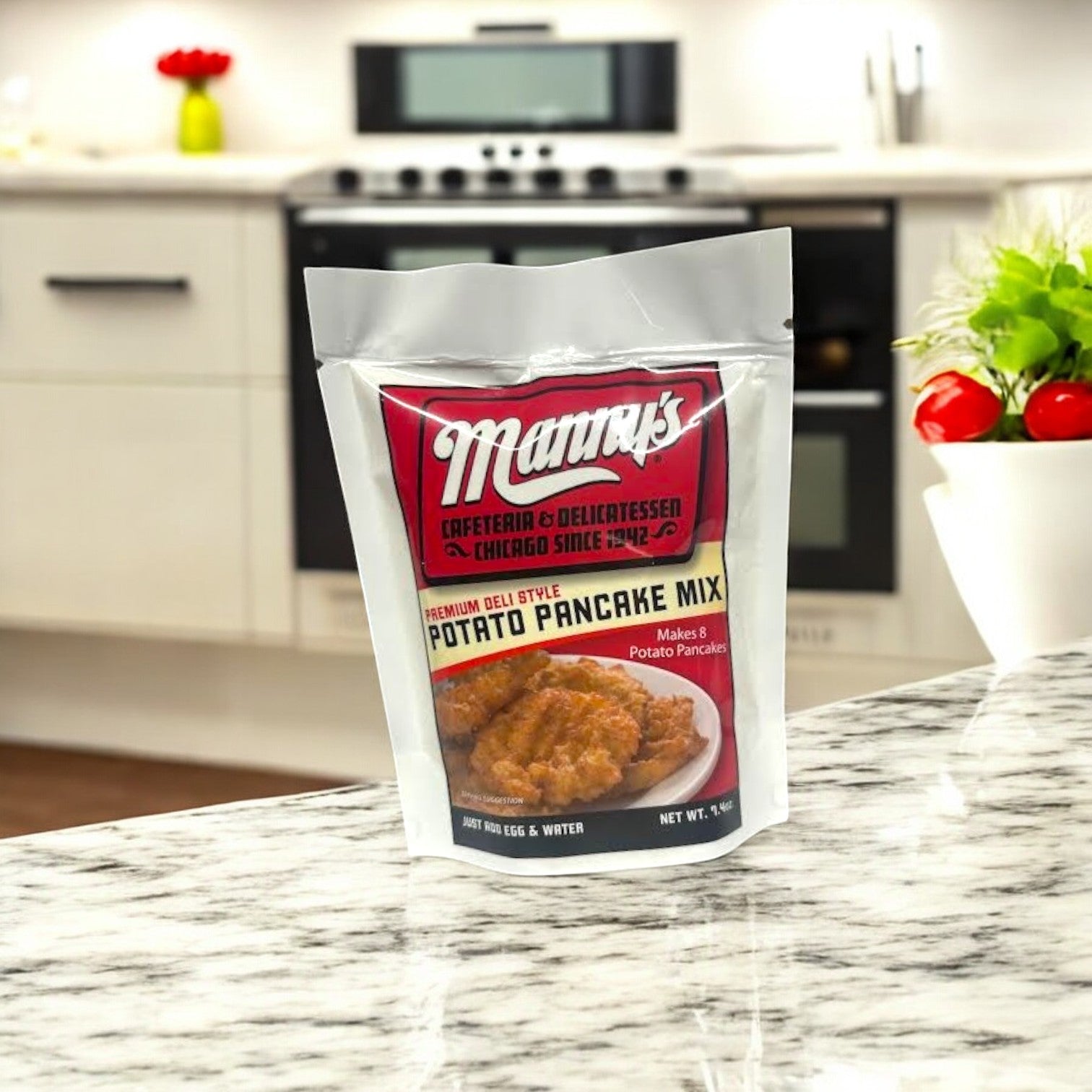A Manny's Deli 4 Count Combo! rests on the marble kitchen counter, evoking a nostalgic Chicago deli atmosphere with thoughts of pastrami and corned beef by the stove and cabinets.