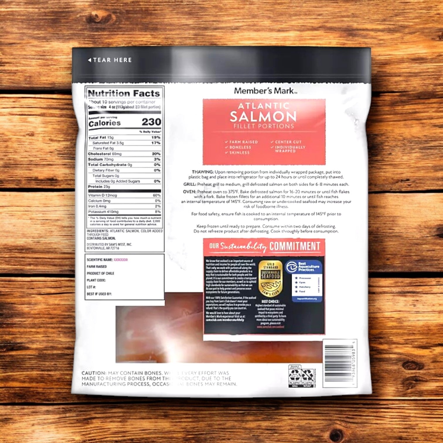 The back of a Member's Mark Atlantic Salmon Fillet Portions package, with nutrition facts and prep instructions on wood, emphasizes omega-3s from sustainable fisheries.