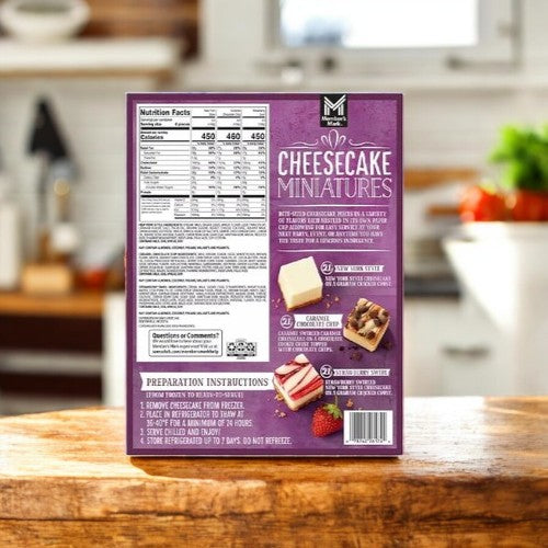 Member's Mark Cheesecake Mini's Variety Pack- 3 Pack with a purple back, featuring nutrition facts, preparation instructions, and images of bite-sized cakes on a wooden kitchen counter.